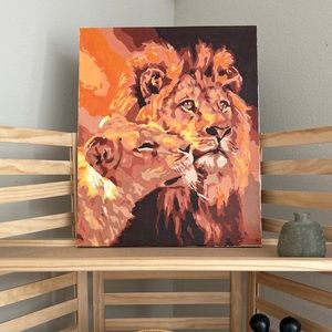 Hand painted lion and lioness artwork in a custom bamboo styled frame